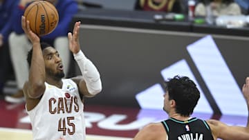Dec 3, 2025; Cleveland, Ohio, USA; Cleveland Cavaliers guard Donovan Mitchell (45) shoots against Portland Trail Blazers forward Deni Avdija (8) in the fourth quarter at Rocket Arena. Mandatory Credit: David Richard-Imagn Images