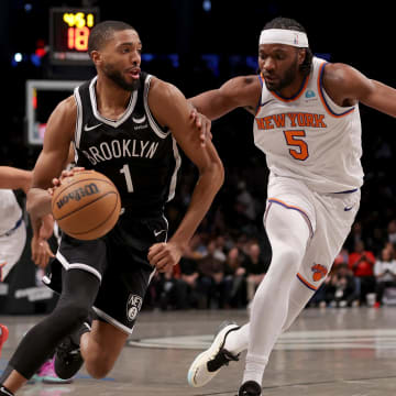 Jan 23, 2024; Brooklyn, New York, USA; Brooklyn Nets forward Mikal Bridges (1) drives to the basket against New York Knicks forward Precious Achiuwa (5) and guard Quentin Grimes (6) during the fourth quarter at Barclays Center. Mandatory Credit: Brad Penner-USA TODAY Sports