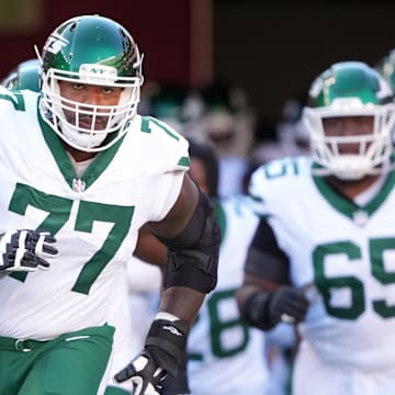 Sep 9, 2024; Santa Clara, California, USA; New York Jets offensive tackle Tyron Smith (77) jogs onto the field before the game against the San Francisco 49ers at Levi's Stadium. 