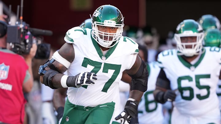 Sep 9, 2024; Santa Clara, California, USA; New York Jets offensive tackle Tyron Smith (77) jogs onto the field before the game against the San Francisco 49ers at Levi's Stadium. Sep 9, 2024; Santa Clara, California, USA; New York Jets offensive tackle Tyron Smith (77) jogs onto the field before the game against the San Francisco 49ers at Levi's Stadium.