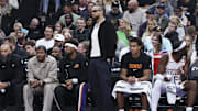 Oct 27, 2025; Salt Lake City, Utah, USA; Phoenix Suns forward Dillon Brooks, center, watches play from the bench wearing street clothes during the second half of a game against the Utah Jazz at Delta Center. Mandatory Credit: Rob Gray-Imagn Images