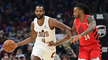 Mar 2, 2025; Cleveland, Ohio, USA; Cleveland Cavaliers forward Evan Mobley (4) brings the ball up court against Portland Trail Blazers forward Jabari Walker (34) during the first half at Rocket Arena. Mandatory Credit: Ken Blaze-Imagn Images