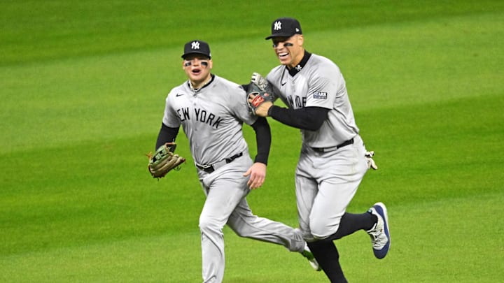 Oct 19, 2024; Cleveland, Ohio, USA; New York Yankees outfielder Alex Verdugo (24) and New York Yankees outfielder Aaron Judge (99) celerbate after beating the Cleveland Guardians during game five of the ALCS for the 2024 MLB playoffs at Progressive Field. Mandatory Credit: David Richard-Imagn Images