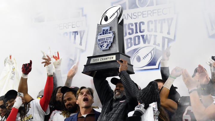 Dec 30, 2023; Nashville, TN, USA; Maryland Terrapins head coach Mike Locksley celebrates with the championship trophy after a win against the Auburn Tigers at Nissan Stadium. Mandatory Credit: Christopher Hanewinckel-USA TODAY Sports