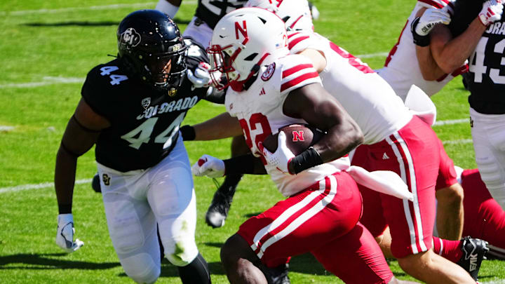 Sep 9, 2023; Boulder, Colorado, USA; Nebraska Cornhuskers running back Gabe Ervin Jr. (22) runs with the ball against Colorado Buffaloes linebacker Jordan Domineck (44) in the first quarter at Folsom Field.