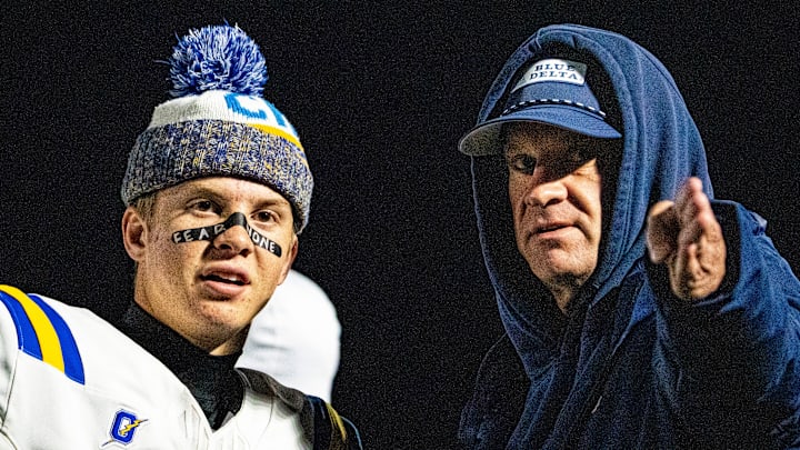 Oxford quarterback Knox Kiffin (13) talks with his dad and Ole Miss football head coach Lane Kiffin on the sidelines during a high school football game between Murrah and Oxford at Hughes Field in Jackson, Miss., on Thursday, Oct. 30, 2025.