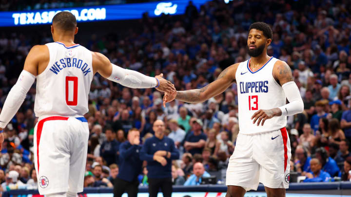 Apr 28, 2024; Dallas, Texas, USA;  LA Clippers guard Russell Westbrook (0) celebrates with LA Clippers forward Paul George (13) during the second half against the Dallas Mavericks during game four of the first round for the 2024 NBA playoffs at American Airlines Center. 