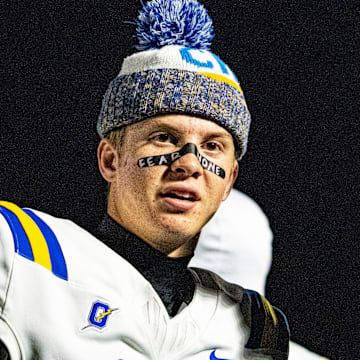 Oxford quarterback Knox Kiffin (13) talks with his dad and Ole Miss football head coach Lane Kiffin on the sidelines during a high school football game between Murrah and Oxford at Hughes Field in Jackson, Miss., on Thursday, Oct. 30, 2025.