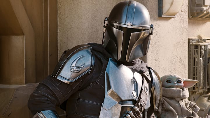 The Mandalorian (Pedro Pascal) and the Child in THE MANDALORIAN, season two, exclusively on Disney+