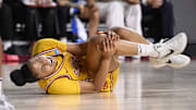 Mar 24, 2025; Los Angeles, California, USA; USC Trojans guard JuJu Watkins (12) grabs her knee after falling to the floor during an NCAA Tournament second round game against the Mississippi State Bulldogs at Galen Center. Mandatory Credit: Robert Hanashiro-Imagn Images