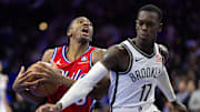 Nov 22, 2024; Philadelphia, Pennsylvania, USA; Philadelphia 76ers guard Tyrese Maxey (0) drives against Brooklyn Nets guard Dennis Schroder (17) during the fourth quarter at Wells Fargo Center. Mandatory Credit: Bill Streicher-Imagn Images