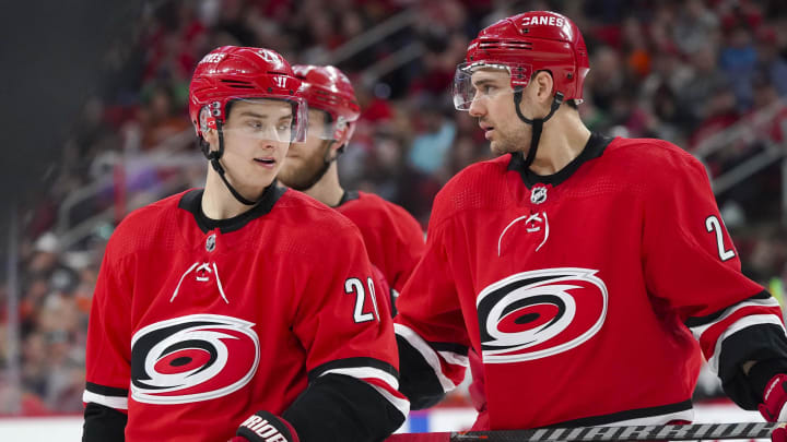 Mar 30, 2019; Raleigh, NC, USA; Carolina Hurricanes center Sebastian Aho (20) and right wing Nino Niederreiter (21) talk during the game against the Philadelphia Flyers at PNC Arena. The Carolina Hurricanes defeated the Philadelphia Flyers 5-2. Mandatory Credit: James Guillory-USA TODAY Sports