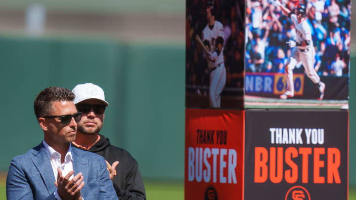 May 7, 2022; San Francisco, California, USA;  Buster Posey listens to speakers during the ceremony to honor him before the start of the game against the St. Louis Cardinals at Oracle Park. 