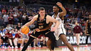 Mar 16, 2023; Orlando, FL, USA; College of Charleston Cougars forward Ante Brzovic (10) goes to the basket while defended by San Diego State Aztecs guard Lamont Butler (5) during the second half at Amway Center. Mandatory Credit: Matt Pendleton-Imagn Images