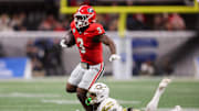Nov 28, 2025; Atlanta, Georgia, USA; Georgia Bulldogs running back Nate Frazier (3) is tackled by Georgia Tech Yellow Jackets defensive back Fenix Felton (31) in the second quarter at Mercedes-Benz Stadium. Mandatory Credit: Brett Davis-Imagn Images