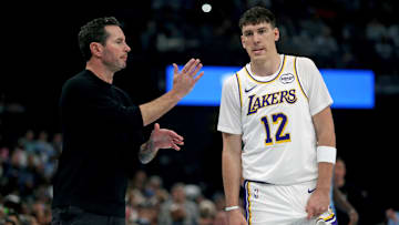 Oct 31, 2025; Memphis, Tennessee, USA; Los Angeles Lakers head coach JJ Redick talks with forward Jake LaRavia (12) during the first quarter against the Memphis Grizzlies at FedExForum. Mandatory Credit: Petre Thomas-Imagn Images