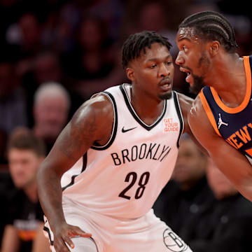 New York Knicks center Ariel Hukporti controls the ball against Brooklyn Nets forward Dorian Finney-Smith. Mandatory Credit: Brad Penner-Imagn Images