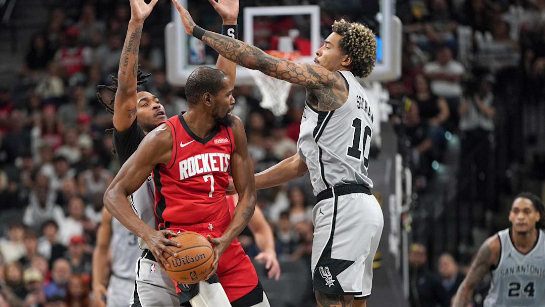 Nov 7, 2025; San Antonio, Texas, USA; San Antonio Spurs guard Stephon Castle (5) and forward Jeremy Sochan (10) guard Houston Rockets forward Kevin Durant (7) during the second half at Frost Bank Center. Mandatory Credit: Dustin Safranek-Imagn Images