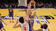 Nov 25, 2025; Los Angeles, California, USA;  Los Angeles Clippers guard Kobe Sanders (4) and guard James Harden (1) defend a shot by Los Angeles Lakers guard Luka Doncic (77) in the second half at Crypto.com Arena. Mandatory Credit: Jayne Kamin-Oncea-Imagn Images