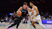 Nov 17, 2025; Miami, Florida, USA; Miami Heat guard Pelle Larsson (9) drives to the basket against New York Knicks guard Landry Shamet (44) during the first quarter at Kaseya Center. Mandatory Credit: Sam Navarro-Imagn Images