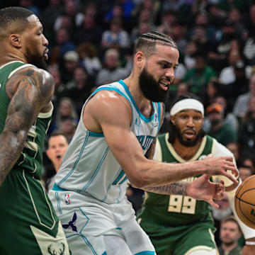 Feb 27, 2024; Milwaukee, Wisconsin, USA;  Charlotte Hornets forward Cody Martin (11) gets pressure from Milwaukee Bucks guard Damian Lillard (0) in the second quarter at Fiserv Forum. 