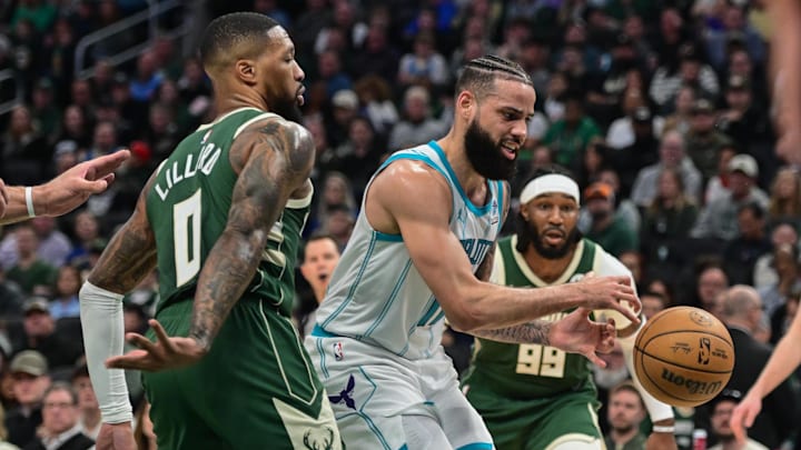 Feb 27, 2024; Milwaukee, Wisconsin, USA;  Charlotte Hornets forward Cody Martin (11) gets pressure from Milwaukee Bucks guard Damian Lillard (0) in the second quarter at Fiserv Forum. 