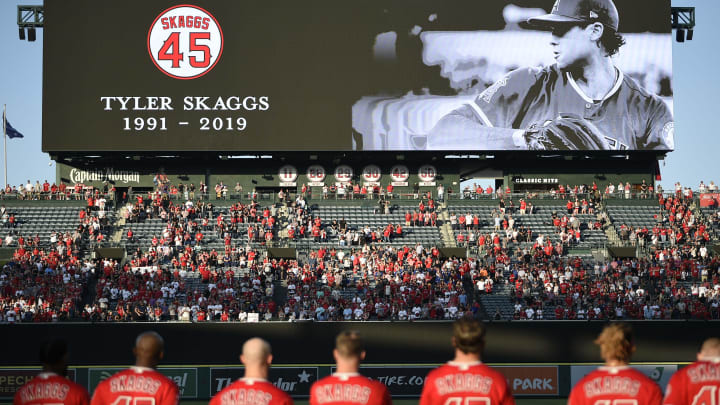 The Los Angeles Angels stand on the field for a moment of silence for late pitcher Tyler Skaggs prior to the game against the Seattle Mariners.