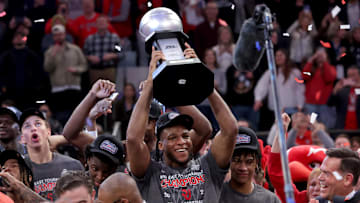 Mar 15, 2025; New York, NY, USA; St. John's basketball forward Zuby Ejiofor (24) hoists the championship trophy after defeating the Creighton Bluejays to win the Big East Tournament at Madison Square Garden.