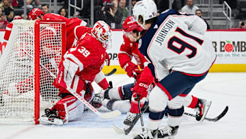 Feb 27, 2025; Detroit, Michigan, USA; Detroit Red Wings goaltender Cam Talbot (39) makes a save against Columbus Blue Jackets center Kent Johnson (91) during the first period at Little Caesars Arena. Mandatory Credit: Tim Fuller-Imagn Images