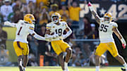 Oct 18, 2025; Tempe, Arizona, USA; Arizona State Sun Devils linebacker Martell Hughes (18) celebrates an interception with teammates Keith Abney II (1) and Justin Wodtly (95) against the Texas Tech Red Raiders in the second half at Mountain America Stadium. Mandatory Credit: Mark J. Rebilas-Imagn Images