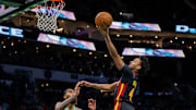 Nov 30, 2024; Charlotte, North Carolina, USA; Atlanta Hawks guard Kobe Bufkin (4) shoots the ball against Charlotte Hornets center Nick Richards (4) during the first quarter at Spectrum Center. Mandatory Credit: Scott Kinser-Imagn Images