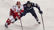 Mar 1, 2025; Columbus, Ohio, USA;  Detroit Red Wings defenseman Moritz Seider (53) skates with the puck against Columbus Blue Jackets right wing Kirill Marchenko (86) in the second period at Ohio Stadium. Mandatory Credit: Aaron Doster-Imagn Images