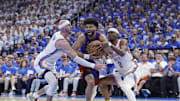 May 13, 2025; Oklahoma City, Oklahoma, USA; Denver Nuggets guard Jamal Murray (27) drives between Oklahoma City Thunder guard Alex Caruso (9) and guard Shai Gilgeous-Alexander (2) during the second quarter of game five of the second round for the 2025 NBA Playoffs at Paycom Center. Mandatory Credit: Alonzo Adams-Imagn Images