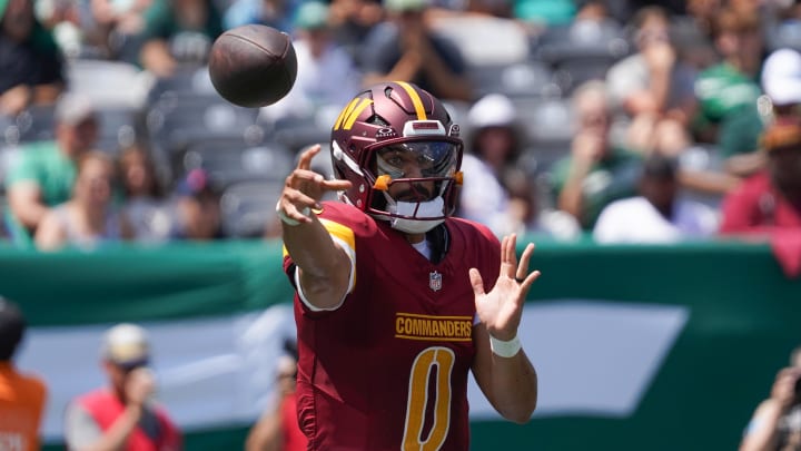 Aug 10, 2024; East Rutherford, New Jersey, USA; Washington Commanders quarterback Marcus Mariota (0) passes during the first quarter against the New York Jets at MetLife Stadium. Mandatory Credit: Lucas Boland-USA TODAY Sports