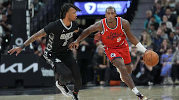 Dec 31, 2024; San Antonio, Texas, USA;  LA Clippers guard Kris Dunn (8) dribbles against San Antonio Spurs guard Stephon Castle (5) in the first half at Frost Bank Center. Mandatory Credit: Daniel Dunn-Imagn Images