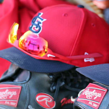 Mar 6, 2019; Tampa, FL, USA; St. Louis Cardinals hat and gloves lay in the dugout at George M. Steinbrenner Field. Mandatory Credit: Kim Klement-Imagn Images