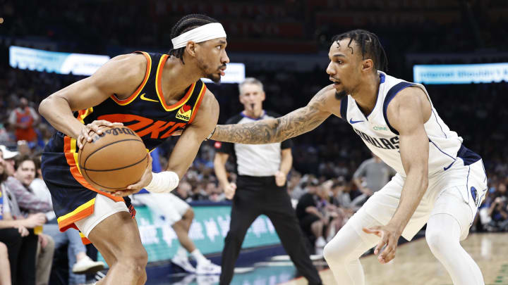 Apr 14, 2024; Oklahoma City, Oklahoma, USA; Oklahoma City Thunder guard Aaron Wiggins (21) is defended by Dallas Mavericks guard A.J. Lawson (9)