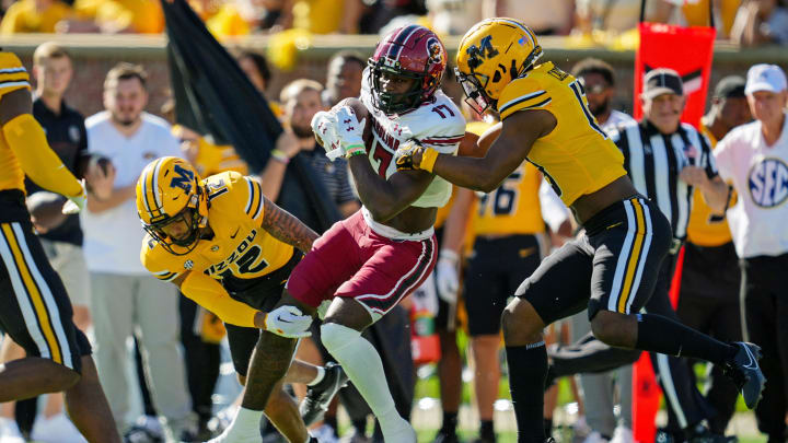 Oct 21, 2023; Columbia, Missouri, USA; South Carolina Gamecocks wide receiver Xavier Legette (17) is tackled by Missouri Tigers defensive back Dreyden Norwood (12) and defensive back Daylan Carnell (13) during the first half at Faurot Field at Memorial Stadium. Mandatory Credit: Jay Biggerstaff-USA TODAY Sports