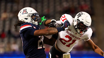 Nov 15, 2024; Tucson, Arizona, USA; Arizona Wildcats defensive back Marquis Groves-Killebrew (20) shoves Houston Cougars running back Stacy Sneed (21) during the third quarter at Arizona Stadium. Mandatory Credit: Aryanna Frank-Imagn Images