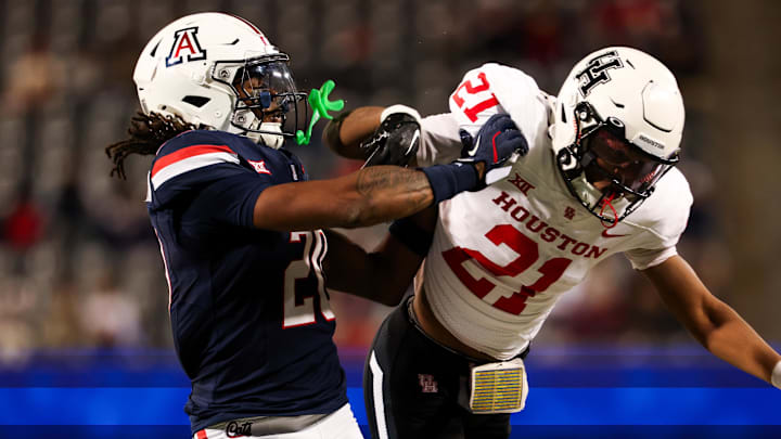 Nov 15, 2024; Tucson, Arizona, USA; Arizona Wildcats defensive back Marquis Groves-Killebrew (20) shoves Houston Cougars running back Stacy Sneed (21) during the third quarter at Arizona Stadium. Mandatory Credit: Aryanna Frank-Imagn Images Nov 15, 2024; Tucson, Arizona, USA; Arizona Wildcats defensive back Marquis Groves-Killebrew (20) shoves Houston Cougars running back Stacy Sneed (21) during the third quarter at Arizona Stadium. Mandatory Credit: Aryanna Frank-Imagn Images