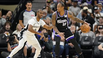 Nov 11, 2024; San Antonio, Texas, USA; Sacramento Kings center guard DeMar DeRozan (10) looks to pass the ball while defended by San Antonio Spurs guard Chris Paul (3) during the first half at Frost Bank Center. Mandatory Credit: Scott Wachter-Imagn Images