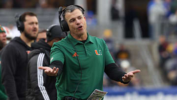 Nov 29, 2025; Pittsburgh, Pennsylvania, USA;  Miami Hurricanes head coach Mario Cristobal reacts on the sidelines against the Pittsburgh Panthers during the third quarter at Acrisure Stadium. 