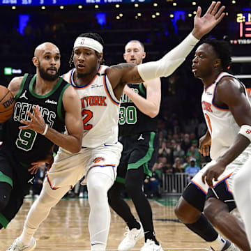 May 14, 2025; Boston, Massachusetts, USA; Boston Celtics guard Derrick White (9) controls the ball while New York Knicks guard Miles McBride (2) defends in the second half during game five of the second round for the 2025 NBA Playoffs at TD Garden. Mandatory Credit: Bob DeChiara-Imagn Images