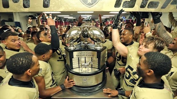 The Army Black Knights celebrate with the Commander-in-Chiefs trophy after a 17-11 win against the Navy Midshipmen