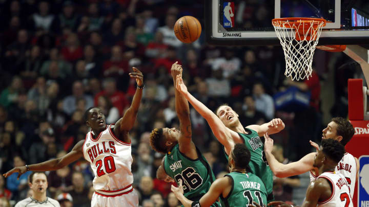 Boston Celtics guard Marcus Smart (36) and center Kelly Olynyk (41) try to keep the ball away from Chicago Bulls forward Tony Snell (20) during the second half at United Center. The Bulls won 101-92. Mandatory Credit: 