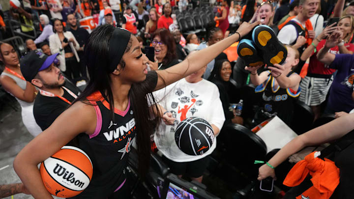 Team WNBA forward Angel Reese (5) hands off her shoes to a young fan after the WNBA All-Star Game at Footprint Center in Phoenix on July 20, 2024.