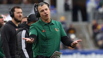 Nov 29, 2025; Pittsburgh, Pennsylvania, USA;  Miami Hurricanes head coach Mario Cristobal reacts on the sidelines against the Pittsburgh Panthers during the third quarter at Acrisure Stadium.