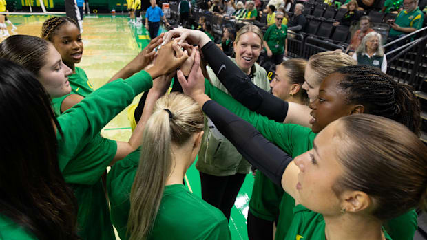 Green team comes together with associate coach Erika Dillard, right, during a scrimmage between teammates 