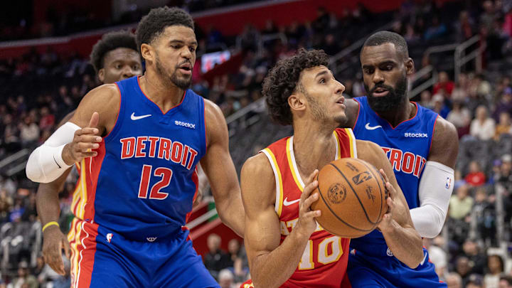 Nov 8, 2024; Detroit, Michigan, USA; Atlanta Hawks forward Zaccharie Risacher (10) battles for position with Detroit Pistons forward Tobias Harris (12) and forward Tim Hardaway Jr. (8): David Reginek-Imagn Images