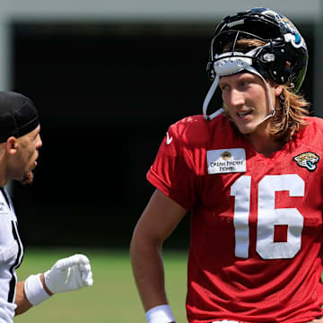 Jacksonville Jaguars wide receiver Parker Washington (11), left, and quarterback Trevor Lawrence (16) talk after an NFL training camp session at the Miller Electric Center, Thursday, Aug. 14, 2025 in Jacksonville, Fla.